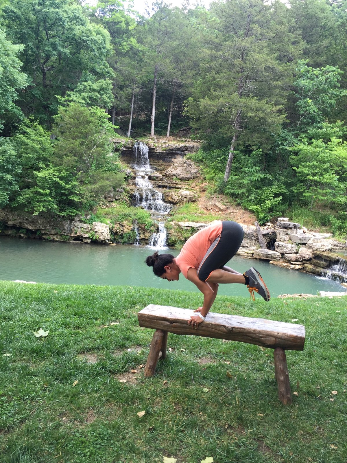 Riddhi practicing an arm balance outdoors